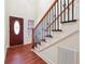 Beautiful foyer with hardwood floors and a staircase featuring black metal spindles and a wood banister at 7902 West Shore Cir, Riverdale, GA 30296