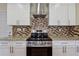 Modern kitchen with granite countertops, stainless steel oven, and tiled backsplash at 7902 West Shore Cir, Riverdale, GA 30296