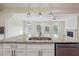 Bright kitchen featuring granite countertops, stainless steel appliances, and an open layout to the living area at 7902 West Shore Cir, Riverdale, GA 30296