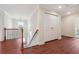 Upstairs landing with hardwood floors and a laundry room at 7902 West Shore Cir, Riverdale, GA 30296