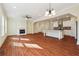 Open-concept living room with fireplace and kitchen, featuring hardwood floors at 7902 West Shore Cir, Riverdale, GA 30296