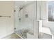 Glass shower featuring white tile, a mosaic drain and a built-in bench at 7902 West Shore Cir, Riverdale, GA 30296