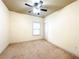 Cozy bedroom featuring plush carpeting, neutral walls, and a ceiling fan at 2050 Harvest Ridge Cir, Buford, GA 30519