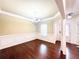 Elegant dining room featuring hardwood floors, decorative molding, and a stylish chandelier at 2050 Harvest Ridge Cir, Buford, GA 30519