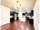 Modern kitchen with stainless steel appliances, an island, and dark cabinets at 2050 Harvest Ridge Cir, Buford, GA 30519