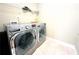 A laundry room with a modern washer and dryer set and wire shelving at 2050 Harvest Ridge Cir, Buford, GA 30519