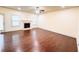 Large living room with hardwood flooring, a cozy fireplace, and natural light at 2050 Harvest Ridge Cir, Buford, GA 30519