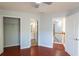 Bedroom features hardwood floors, neutral paint and multiple entryways to other areas of the home at 2875 Factor Walk Blvd, Suwanee, GA 30024