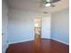 Bedroom with hardwood floors, ceiling fan and an entry way that features a staircase at 2875 Factor Walk Blvd, Suwanee, GA 30024
