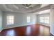 Spacious bedroom featuring hardwood floors, tray ceiling, and multiple windows at 2875 Factor Walk Blvd, Suwanee, GA 30024