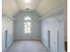 Walk-in closet featuring carpet, wire shelving, an arched window and two access doors at 2875 Factor Walk Blvd, Suwanee, GA 30024