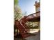 Stairs leading up to the deck from a concrete patio, under the deck, with lovely yard and blooming trees at 2875 Factor Walk Blvd, Suwanee, GA 30024