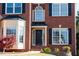 Close-up of the front door and portico, highlighting brick facade and neat landscaping at 2875 Factor Walk Blvd, Suwanee, GA 30024