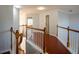 Upstairs hallway featuring hardwood floors, wooden railings and trim at 2875 Factor Walk Blvd, Suwanee, GA 30024