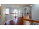 Upstairs hallway featuring hardwood floors, wooden railings and trim at 2875 Factor Walk Blvd, Suwanee, GA 30024