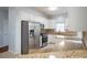 Bright kitchen featuring stainless steel appliances, granite countertops, and white cabinetry at 2875 Factor Walk Blvd, Suwanee, GA 30024