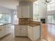Open concept living room showcasing large windows, a fireplace, and views from the kitchen area at 2875 Factor Walk Blvd, Suwanee, GA 30024