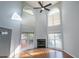 Spacious living room with high ceilings, fireplace, large windows, and lots of natural light at 2875 Factor Walk Blvd, Suwanee, GA 30024
