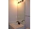 Bathroom vanity with marble countertop, black faucet, mirror, and light fixture at 3516 Ashley Station Sw Dr, Marietta, GA 30008