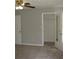 Cozy bedroom with ceiling fan, carpeting, neutral paint, and walk-in closet at 3516 Ashley Station Sw Dr, Marietta, GA 30008