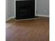 Close up of fireplace with dark surround and wood-look laminate floors at 3516 Ashley Station Sw Dr, Marietta, GA 30008