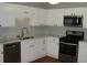 Bright kitchen featuring stainless steel appliances, marble counter tops and white cabinetry at 3516 Ashley Station Sw Dr, Marietta, GA 30008