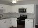 Bright kitchen with stainless steel appliances and white cabinets at 3516 Ashley Station Sw Dr, Marietta, GA 30008