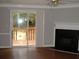 Bright living room featuring hardwood floors, fireplace, and sliding door to deck at 3516 Ashley Station Sw Dr, Marietta, GA 30008