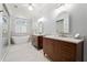 Luxurious bathroom featuring double vanities, a soaking tub, and a separate glass-enclosed shower at 4045 Stephens Mill Ne Run, Atlanta, GA 30342
