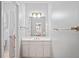 Clean bathroom features a white vanity with sink, cabinet storage, and a large framed mirror at 4045 Stephens Mill Ne Run, Atlanta, GA 30342