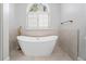Elegant freestanding bathtub by a large window, creating a serene and spa-like bathroom at 4045 Stephens Mill Ne Run, Atlanta, GA 30342