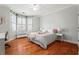 Cozy bedroom featuring wood floors, natural light, and decorative accents at 4045 Stephens Mill Ne Run, Atlanta, GA 30342