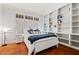 Comfortable bedroom with built-in bookshelves, hardwood floors, and bright natural light at 4045 Stephens Mill Ne Run, Atlanta, GA 30342