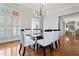 Modern dining room with glass table, white chairs, and large windows providing natural light at 4045 Stephens Mill Ne Run, Atlanta, GA 30342