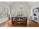 Bright dining room with large windows, vaulted ceilings, a chandelier, and a rustic wood table, perfect for gatherings at 4045 Stephens Mill Ne Run, Atlanta, GA 30342