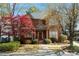 Charming brick home featuring a manicured lawn, mature trees, and classic architectural details, creating inviting curb appeal at 4045 Stephens Mill Ne Run, Atlanta, GA 30342