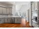 Stylish kitchen with stainless steel appliances, gray cabinetry, and hardwood floors, offering a perfect blend of elegance and practicality at 4045 Stephens Mill Ne Run, Atlanta, GA 30342