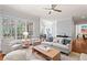 Inviting living room with large windows, neutral furniture, and hardwood floors, creating a comfortable and stylish gathering space at 4045 Stephens Mill Ne Run, Atlanta, GA 30342