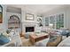 Bright and airy living room featuring a fireplace, built-in shelving, and large windows at 4045 Stephens Mill Ne Run, Atlanta, GA 30342