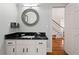 Stylish powder room with modern vanity, granite countertop, and elegant mirror at 4045 Stephens Mill Ne Run, Atlanta, GA 30342