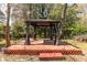 A beautiful gazebo on a raised deck is centered in a lush backyard surrounded by mature trees at 1864 Crestridge Ne Pl, Atlanta, GA 30345