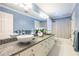 Bathroom featuring double sinks, granite countertops, and bright lighting at 1864 Crestridge Ne Pl, Atlanta, GA 30345