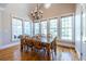 Bright dining room features hardwood floors, large windows, and a modern chandelier at 1864 Crestridge Ne Pl, Atlanta, GA 30345