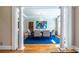 Formal dining room with hardwood floors, statement lighting, columns, and bright blue rug at 1864 Crestridge Ne Pl, Atlanta, GA 30345