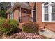 Charming brick home featuring blooming shrubs and stylish front door at 1864 Crestridge Ne Pl, Atlanta, GA 30345
