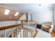 Upstairs hallway with hardwood floors, natural light, and comfortable sitting area at 1864 Crestridge Ne Pl, Atlanta, GA 30345