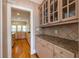 Eat-in kitchen featuring hardwood floors, granite countertops, and built-in cabinets at 1864 Crestridge Ne Pl, Atlanta, GA 30345