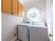 Efficient laundry room with modern washer and dryer and above storage at 1864 Crestridge Ne Pl, Atlanta, GA 30345