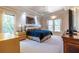 Spacious main bedroom with tray ceilings, large windows, carpeted floors, and elegant furnishings at 1864 Crestridge Ne Pl, Atlanta, GA 30345