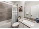Bathroom featuring a bathtub with a shower and decorative gray tiling at 2068 Cortland Rd, Milton, GA 30009